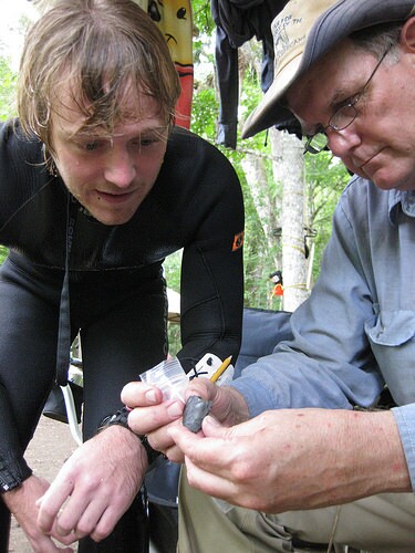 Morgan Smith and Michael R. Waters examining biface